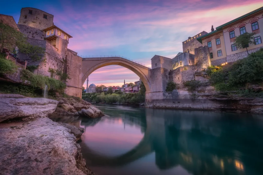 The Old Bridge in Mostar reflected in the Neretva river at sunset