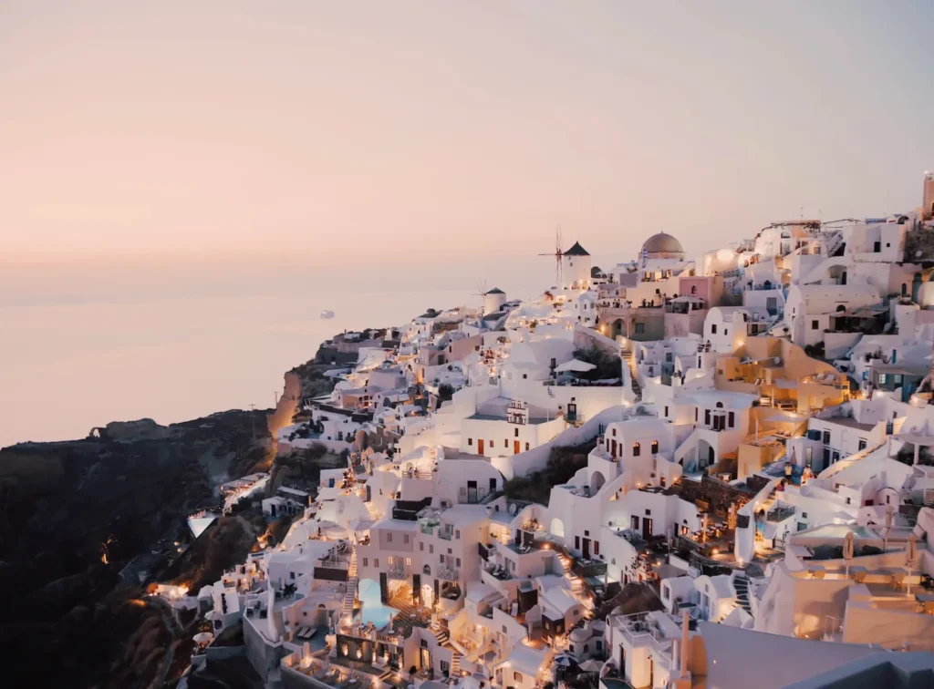White houses and windmills of Oia, Santorini, at sunset